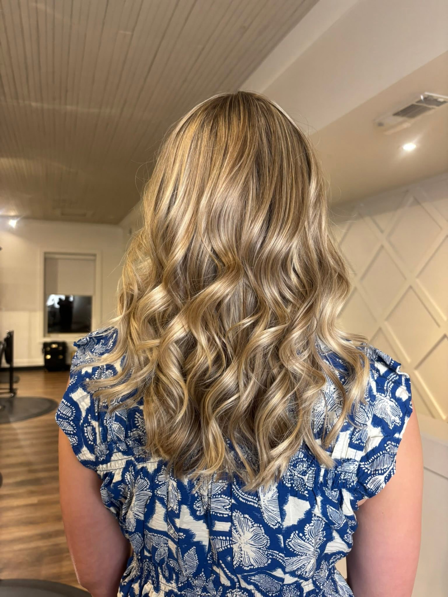 Golden blonde balayage with soft beachy waves by Isabella Romeo, hairstylist in McAdenville, NC